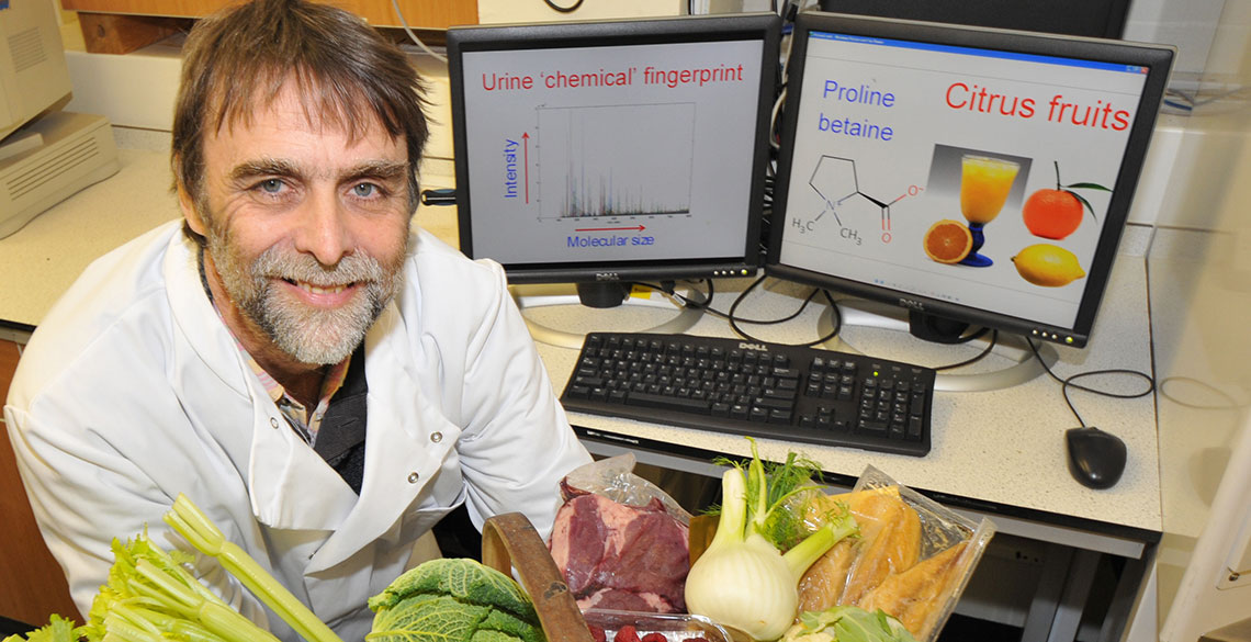 Professor John Draper in front of a computer, with vegetables