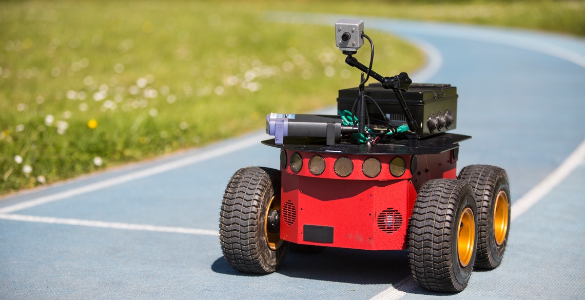 Four-wheel pioneer robot driving along a running track