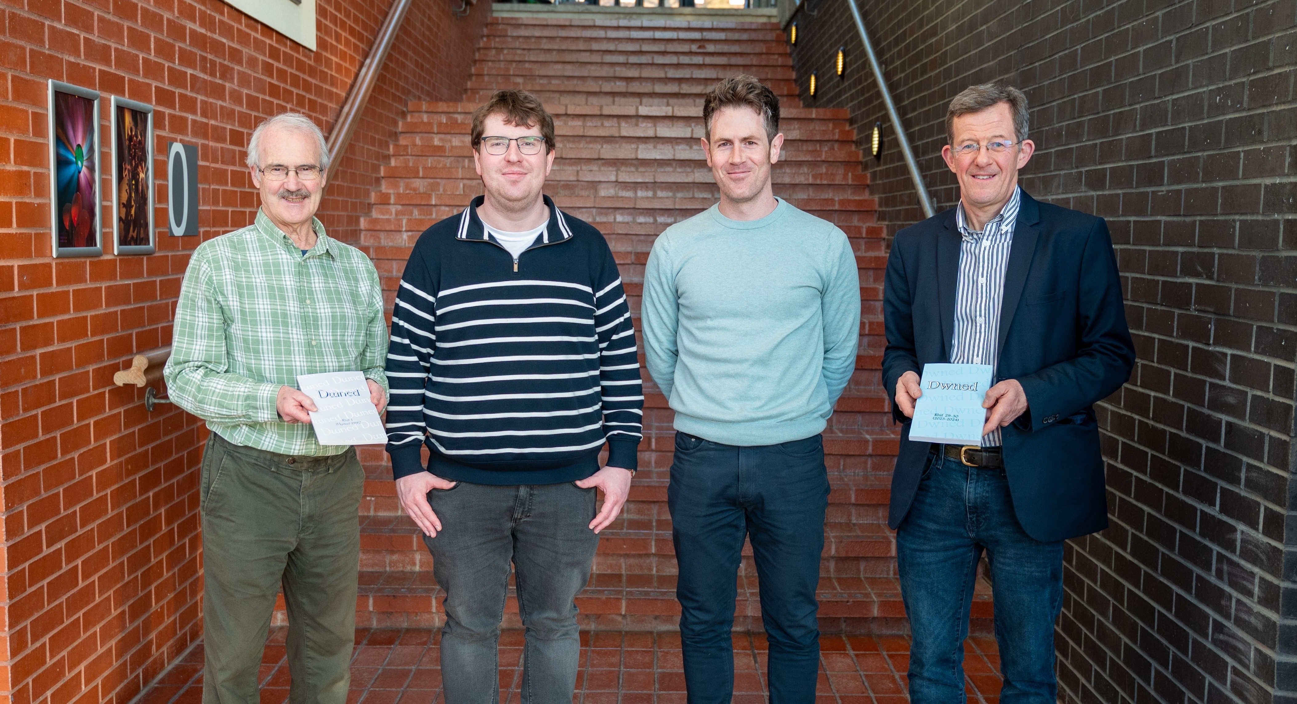 Dwned editors old and new – Dr Cynfael Lake, Dr Gruffudd Antur, Dr Eurig Salisbury and Dr Bleddyn Huws