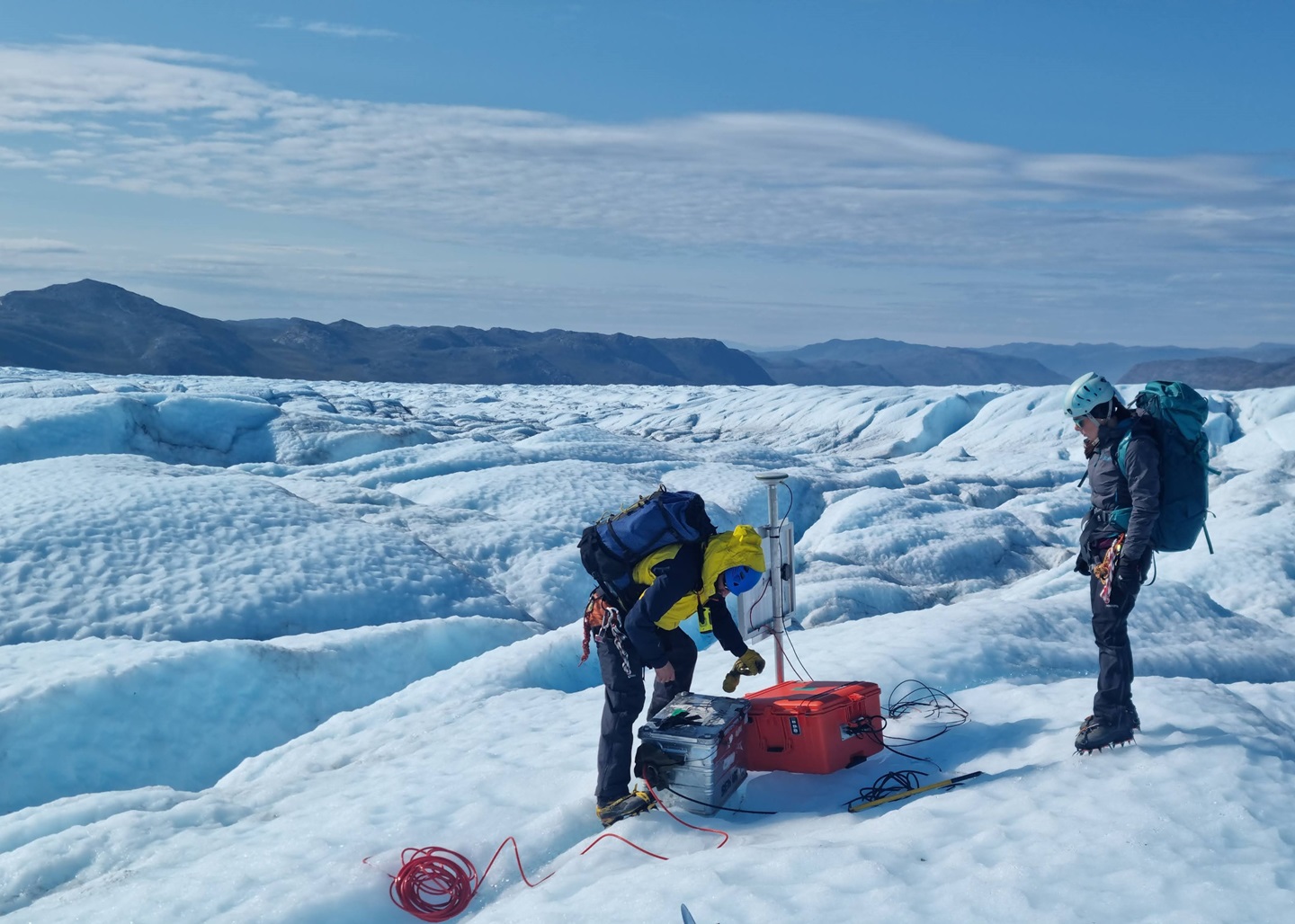 Dr Samuel Doyle (left) maintaining a seismometer on the Greenland Ice Sheet. 