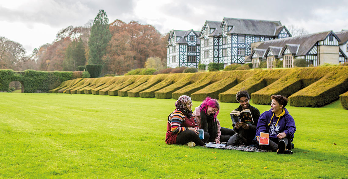 Students sitting on the lawn at Gregynog