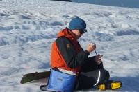 Dr Arwyn Edwards, a lecturer in Biological Sciences at IBERS, collecting samples of blooming bacteria on Svalbard.
