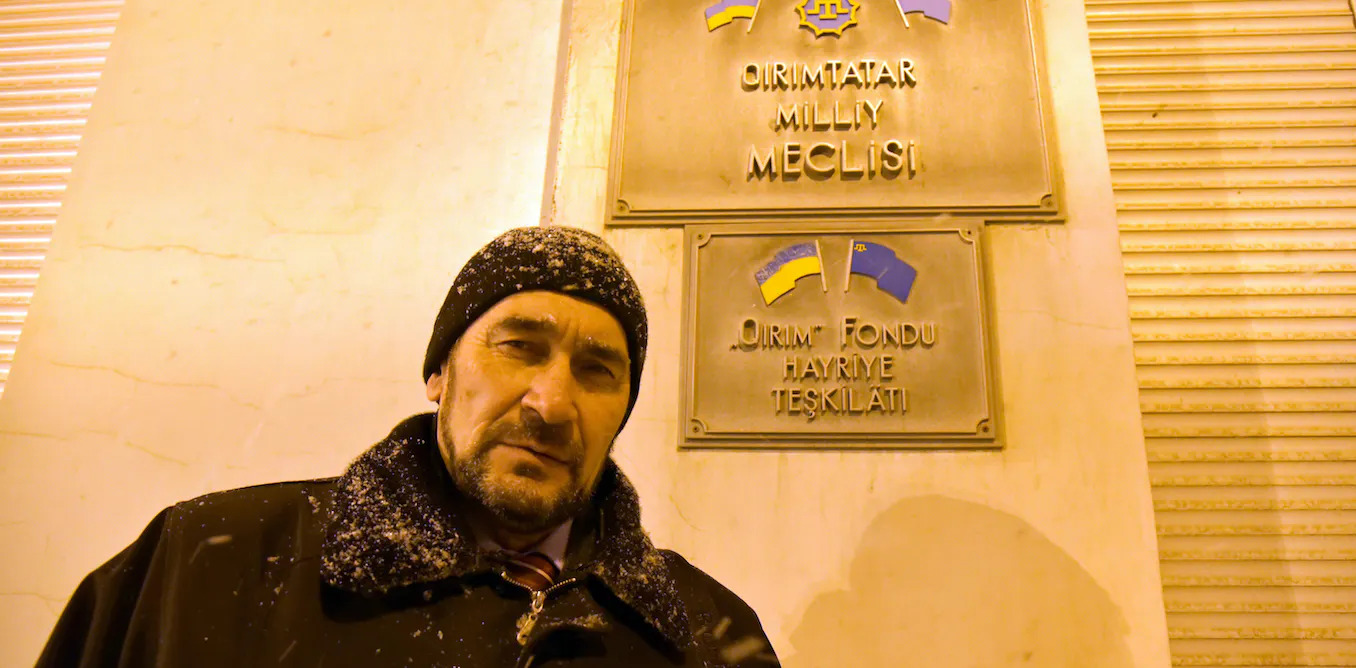 Activist Sair Smedlja stands in front of the Crimean Tatar self-governing assembly (the Mejlis) which was closed down when the Russians occupied Crimea. DPA/Alamy