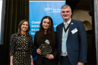 Veterans Legal Link case worker Megan Perrins (centre) accepting the award on behalf of the team at the award ceremony in London on 4 December 2024, with event host and political commentator Tamara Cohen and Vice President of the Law Society of England and Wales, Mark Evans. 