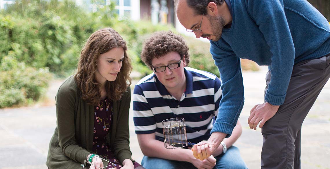 A lecturer showing students the shape and properties of a bubble