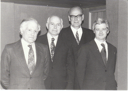 Group of staff or associates of the University. Left to right: Dr. Brynley Roberts; Prof. J.E. Caerwyn Williams; Sir Goronwy Hopkin Daniel (Principal); Prof. R. Geraint Gruffydd. Estimated date: 1970s.