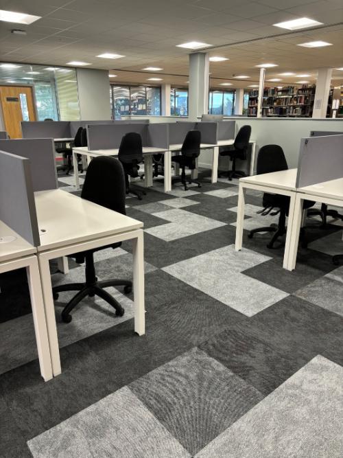 desks and the view to the books on shelves on Level E