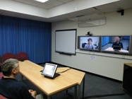 Mr Geoff Constable videoconferencing with a colleague.