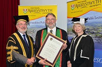 Dr Glyn Rowlands BSc PhD, Vice-President, Professor Douglas Kell CBE, Fellow and Professor April McMahon, Vice-Chancellor