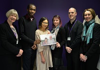 From left to right: Vice-chancellor April McMahon, the scholarship recipients Olu Ashiru, Sabine Klein, and Denitsa Peneva, George Jones, Senior Student Advisor and Louise Jagger, Director of DARO. Olu, Sabine and Denitsa are holding a photograph of scholarship founders Peter Hancock and Patricia Pollard.