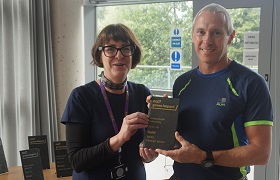 Pro Vice-Chancellor and Chief Operating Officer, Rebecca Davies presenting Sport & Exercise Science Technician, Alan Cole, with the Gold Standard Green Impact Award for IBERS (Carwyn James).