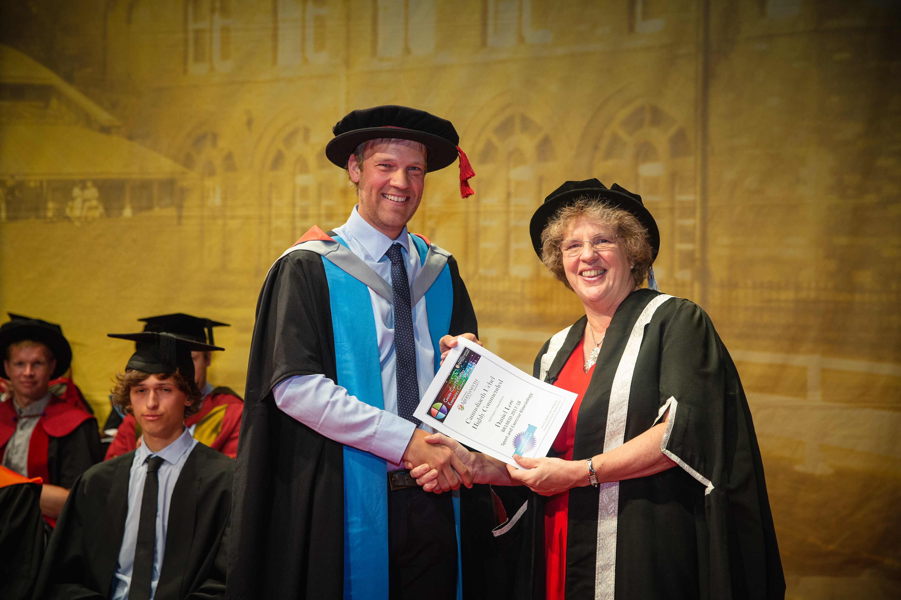 Dr Daniel Low from the Institute of Biological, Environmental and Rural Sciences receiving his highly commended certificate in the 2017-18 Exemplary Course Awards from Vice-Chancellor Professor Elizabeth Treasure during Graduation Week 2018