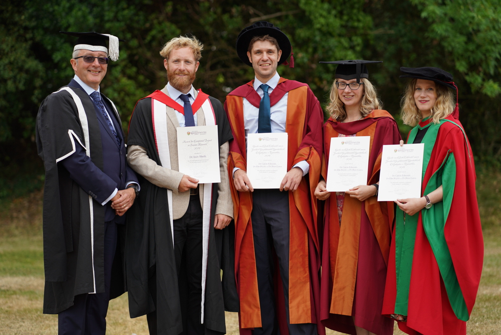 The winners of Aberystwyth University’s inaugural Awards for Exceptional Impact in Research are Dr Andy Hardy from the Department of Geography and Earth Sciences, and Dr Catrin Wyn Edwards, Dr Huw Lewis and Dr Elin Royles from the Department of International Politics, pictured here with Pro Vice-Chancellor Professor John Grattan.