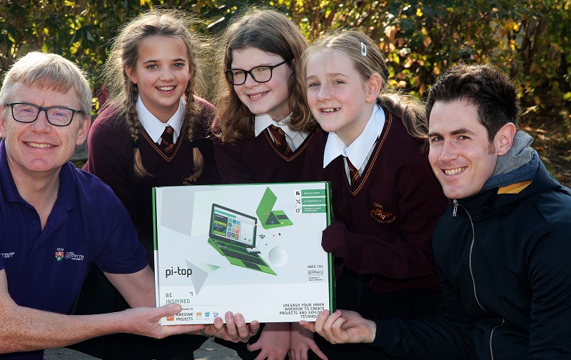 Dr Martin Nelmes (left) and Eurig Salisbury from Aberystwyth University present a pi-top computer to Eleanor Ingham, Awen Dafydd and Caitlin Valintine from Ysgol Bro Gwydir, winners of the Scratch Animation Competition for Primary Schools in Wales.