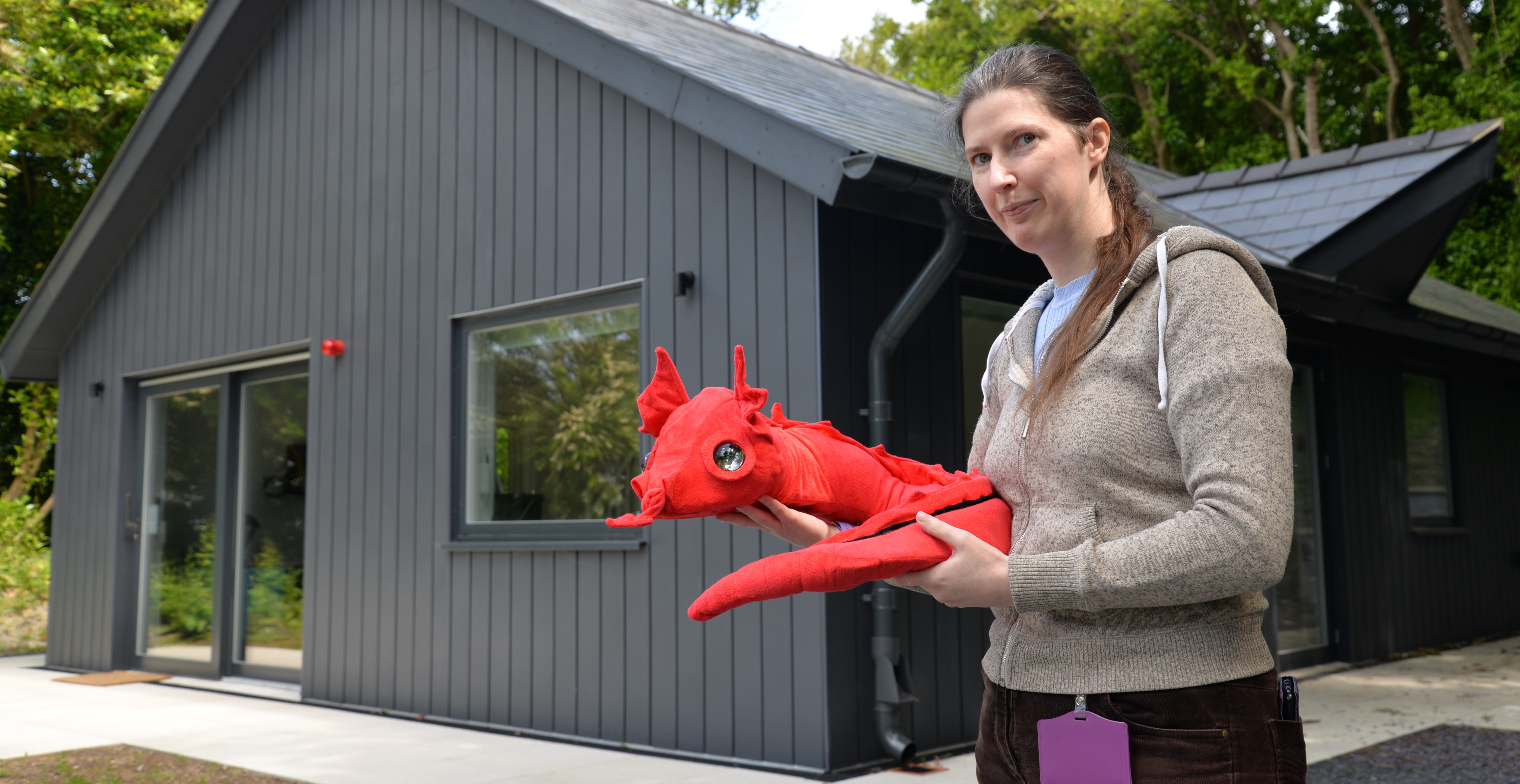 Dr Patricia Shaw and the yet-to-be-named robotic dragon outside the new Smart Home Lab where robots are being tested for how they might be able to help older people live independently for longer.