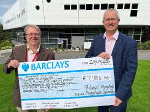 Mike May, Regional Funding Manager for Wales Air Ambulance being presented with a cheque by Aberystwyth University Vice-Chancellor, Professor Jon Timmis