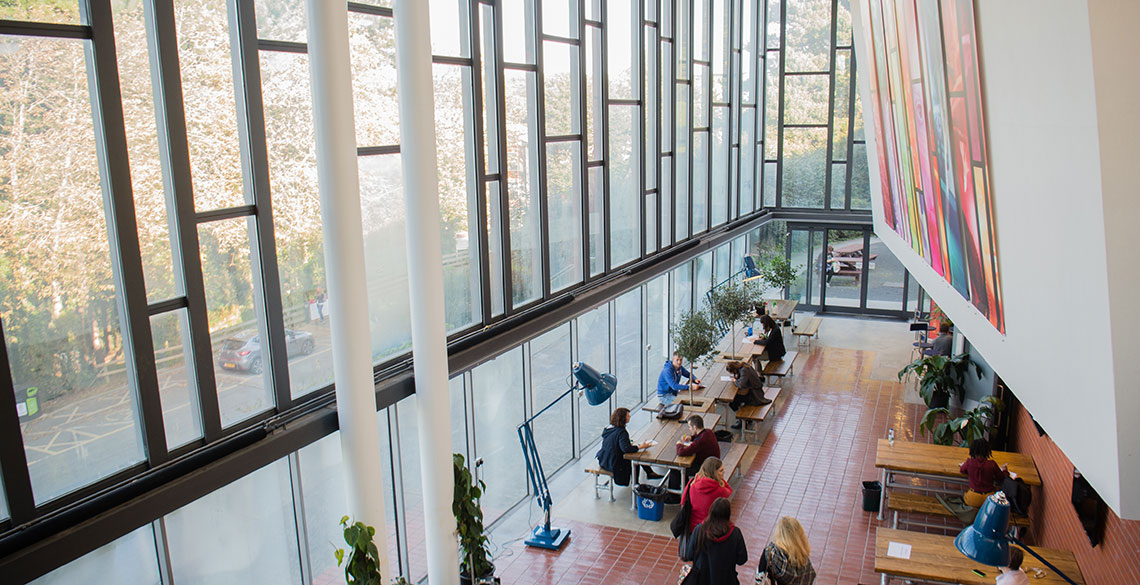 People sitting and walking around in the Foyer of the Parry Williams Building