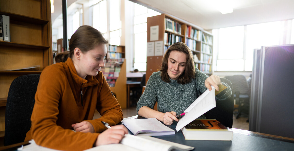 Students looking at book