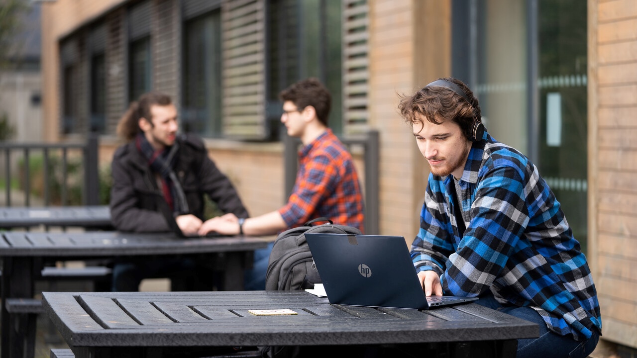 Student on a computer with headphones