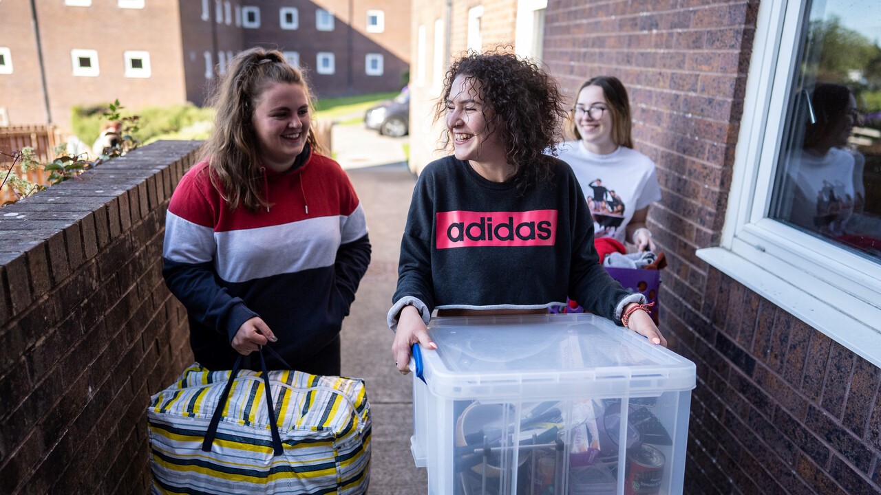 Students carrying boxes