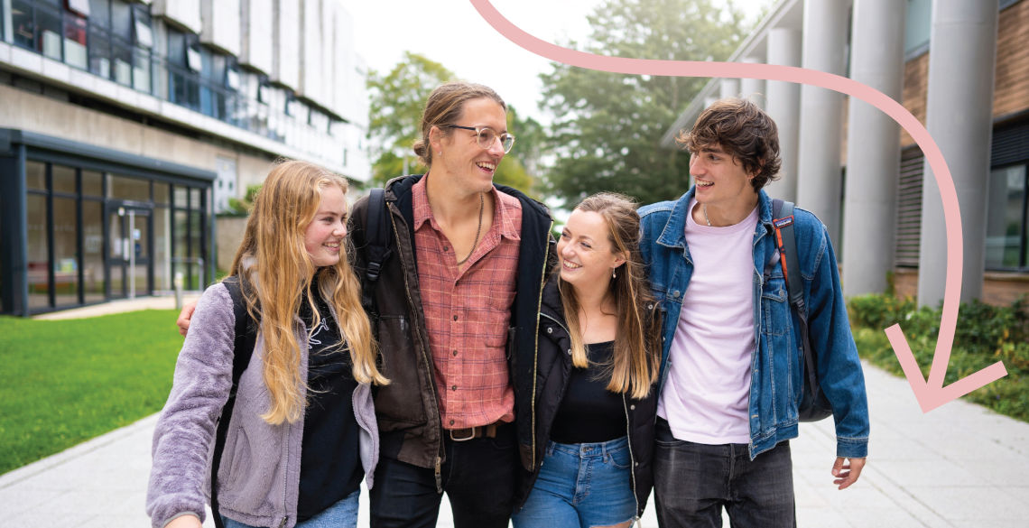 Group of 4 students walking on campus